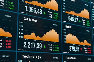 Stock market and exchange monitor with oil and gas sector chart. Oil and gas stocks, chart moving up. Stock market and e